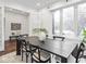 Bright dining room with dark table set, light rug, and large windows at 1326 E 10Th St, Indianapolis, IN 46202