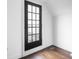 Entry door that features a paneled glass door with dark hardwood floors and crisp white trim at 1326 E 10Th St, Indianapolis, IN 46202