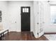 Beautiful entryway with a black front door, white trim and hardwood flooring at 1326 E 10Th St, Indianapolis, IN 46202