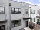 Modern townhouse featuring stylish gray siding, black trim windows, and a cozy fenced patio at 1326 E 10Th St, Indianapolis, IN 46202