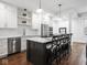 Bright kitchen featuring quartz counters, white subway tile, stainless appliances, and island bar seating at 1326 E 10Th St, Indianapolis, IN 46202