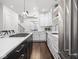 Stylish kitchen featuring a gas range cooktop on the large island with white countertops at 1326 E 10Th St, Indianapolis, IN 46202