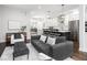 Open-concept living room and kitchen featuring modern design and hardwood flooring at 1326 E 10Th St, Indianapolis, IN 46202