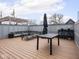 Stylish rooftop deck featuring wood decking, seating, an umbrella, and an outdoor kitchen area at 1326 E 10Th St, Indianapolis, IN 46202