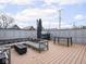 Spacious rooftop deck with wood flooring, cozy seating, and a dining area with scenic views at 1326 E 10Th St, Indianapolis, IN 46202