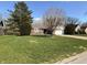 Lovely single-story brick home with a well-manicured lawn, mature trees, and an attached two-car garage at 1348 Secretariat Ln, Indianapolis, IN 46217