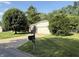Charming single-story home with brick and siding, lush lawn, mature trees, and an inviting front entrance at 1348 Secretariat Ln, Indianapolis, IN 46217