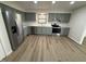 Well-lit kitchen featuring stainless steel appliances, gray cabinets, and light countertops at 1348 Secretariat Ln, Indianapolis, IN 46217