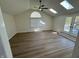 Bright living room with vaulted ceilings, skylights, and access to an outdoor deck at 1348 Secretariat Ln, Indianapolis, IN 46217