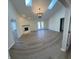 Spacious living room with vaulted ceilings, skylights, fireplace, and access to the backyard through french doors at 1348 Secretariat Ln, Indianapolis, IN 46217