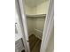This spacious walk-in closet features wood flooring, rod racks, and is freshly painted at 1348 Secretariat Ln, Indianapolis, IN 46217