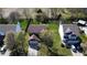 Aerial view of a home with a well-maintained lawn, mature trees, and a driveway leading to the garage at 13660 N Ayrshire Cir, Camby, IN 46113