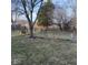 View of the backyard with a swing set, mature trees, green grass, and a fenced perimeter for privacy at 13660 N Ayrshire Cir, Camby, IN 46113