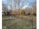 Fenced backyard featuring green grass and mature trees with a decorative garden area and plenty of privacy at 13660 N Ayrshire Cir, Camby, IN 46113