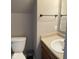 A bathroom features a toilet, cabinet with sink, and a mirror at 13660 N Ayrshire Cir, Camby, IN 46113