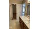 Bathroom with tan cabinets and view of a walk-in closet and another room through doorways at 13660 N Ayrshire Cir, Camby, IN 46113