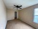 Bedroom with a ceiling fan, window, tan walls, and carpet flooring at 13660 N Ayrshire Cir, Camby, IN 46113
