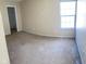 Bedroom with a window, closet, tan walls, and carpet flooring at 13660 N Ayrshire Cir, Camby, IN 46113