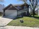 Charming two-story home with a brick facade, attached garage, and well-maintained lawn at 13660 N Ayrshire Cir, Camby, IN 46113