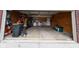 Open garage with storage and workspace, offering functional space for parking and DIY projects at 13660 N Ayrshire Cir, Camby, IN 46113