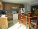 Bright kitchen featuring wood cabinetry, stainless steel appliances and a dining table with chairs at 13660 N Ayrshire Cir, Camby, IN 46113
