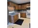Functional kitchen with wood cabinetry, stainless steel sink, and modern appliances at 13660 N Ayrshire Cir, Camby, IN 46113