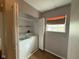 Laundry room with a side-by-side washer and dryer, storage, and a window at 13660 N Ayrshire Cir, Camby, IN 46113