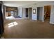 A spacious living room with a carpet and a view of the kitchen at 13660 N Ayrshire Cir, Camby, IN 46113