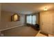 Inviting living room showcasing neutral walls, carpeted floors, and a unique wall mirror at 13660 N Ayrshire Cir, Camby, IN 46113