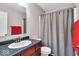 Bathroom featuring dark cabinets, granite countertops, a white toilet and a shower with a gray curtain at 159 Longleaf Ln, Greenfield, IN 46140