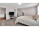 A large bedroom features neutral colors, carpet floors, and a doorway to an en-suite bathroom at 159 Longleaf Ln, Greenfield, IN 46140