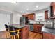 This kitchen features stainless steel appliances, an island with seating, and wooden cabinets at 159 Longleaf Ln, Greenfield, IN 46140