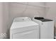 Functional laundry room featuring a white washer and dryer set and wire shelving at 159 Longleaf Ln, Greenfield, IN 46140