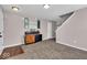Inviting living room space with modern décor, storage cabinet, and staircase to the upper level at 159 Longleaf Ln, Greenfield, IN 46140
