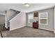 The spacious living room has natural light, neutral walls, plush carpet, and a staircase at 159 Longleaf Ln, Greenfield, IN 46140