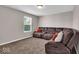 Cozy living room features plush carpeting and a comfortable sectional sofa, ideal for relaxing at 159 Longleaf Ln, Greenfield, IN 46140