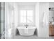Modern bathroom with a stand-alone tub, glass-enclosed shower, and tile floors at 17354 Ditch Rd, Westfield, IN 46074