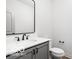 Elegant bathroom featuring a modern vanity with sleek black hardware and a framed mirror at 17354 Ditch Rd, Westfield, IN 46074