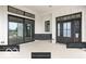 Exterior view of a home showing black framed windows, doors, and micro aggregate surface at 17354 Ditch Rd, Westfield, IN 46074