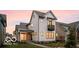 Beautiful two-story white home with black trim and a balcony at sunset at 17354 Ditch Rd, Westfield, IN 46074