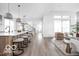 Sunlit open concept kitchen and living room with hardwood floors and white walls at 17354 Ditch Rd, Westfield, IN 46074