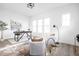 Stylish home office with natural light, a desk, comfy chairs, and hardwood floors at 17354 Ditch Rd, Westfield, IN 46074