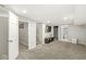 Finished basement with plush carpeting, open staircase, and a view of the basement bathroom at 1741 Caldwell Pl, Columbus, IN 47201