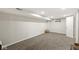 Finished basement with plush carpeting, a basket for storage, and a small window at 1741 Caldwell Pl, Columbus, IN 47201