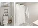 Basement bathroom features mosaic flooring, framed art, and a shower with a curtain at 1741 Caldwell Pl, Columbus, IN 47201