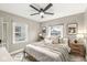 Neutral bedroom with a ceiling fan, two windows, and a cozy bed at 1741 Caldwell Pl, Columbus, IN 47201