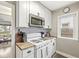 Well-equipped kitchen with white cabinets, a gas range, and a view into the living space at 1741 Caldwell Pl, Columbus, IN 47201