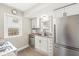 Modern kitchen featuring stainless steel appliances, white cabinetry, and a window view at 1741 Caldwell Pl, Columbus, IN 47201