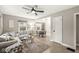 Bright living room with a large sectional couch, ceiling fan, and hardwood floors at 1741 Caldwell Pl, Columbus, IN 47201