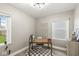 Bright home office with natural light, neutral decor, and decorative macrame wall hanging at 1741 Caldwell Pl, Columbus, IN 47201